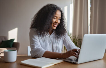 Woman Using Laptop at Home